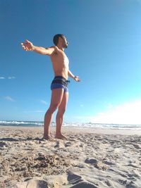 Full length of man standing on beach