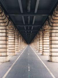 Empty road along buildings