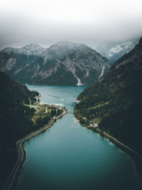 Scenic view of lake and mountains against sky