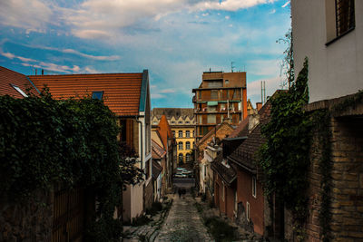 Street amidst buildings in town against sky