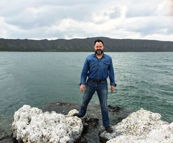 Portrait of young man standing on rock