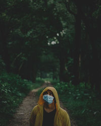 Portrait of man standing in forest