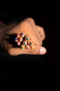 Close-up of woman hand over black background