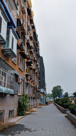 A quiet beijing street lined with orange apartments