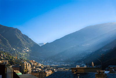 Town in the pyrenees mountains against clear blue sky