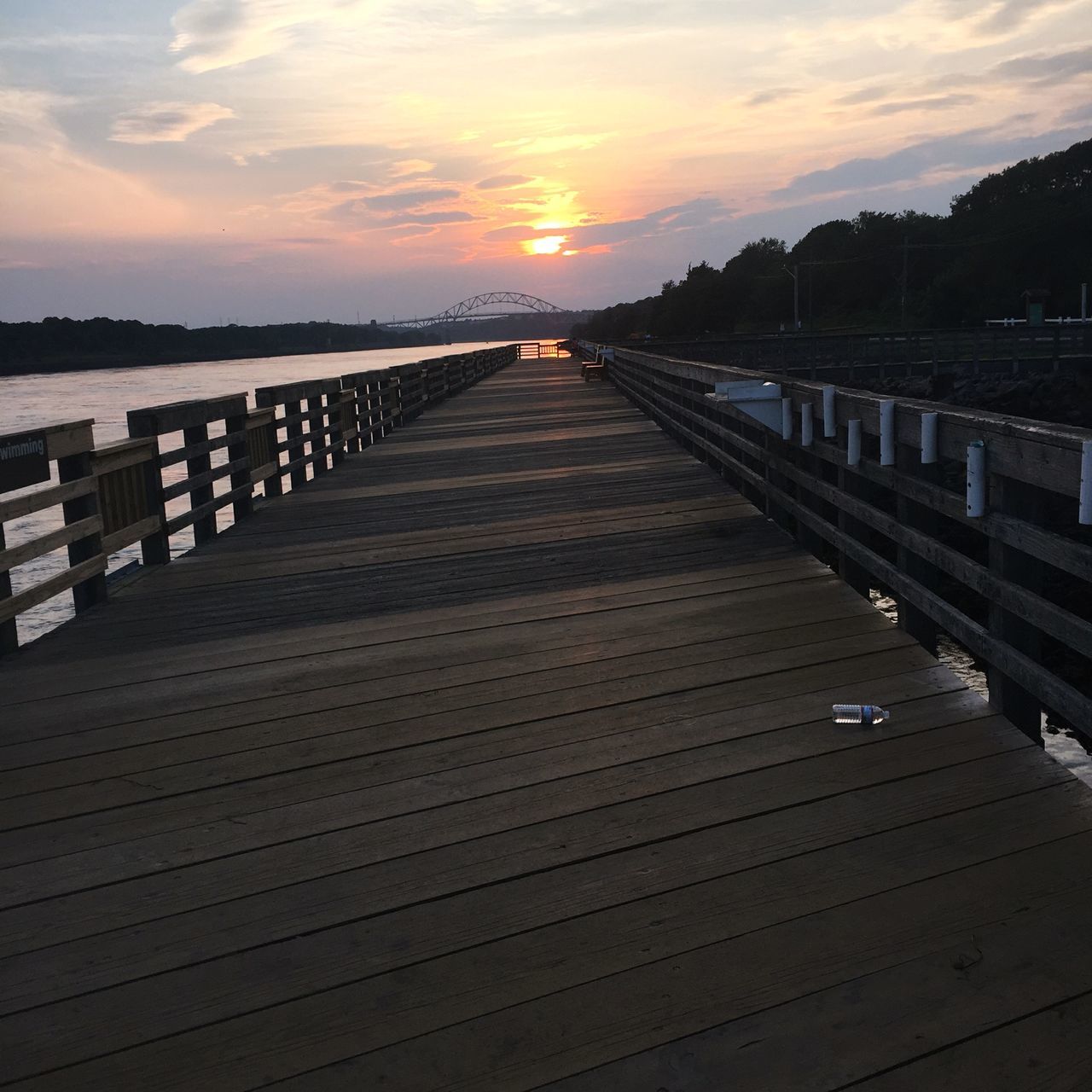 VIEW OF PIER OVER SEA DURING SUNSET