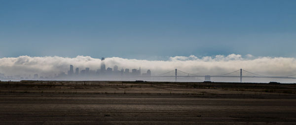 View of bridge over land against sky