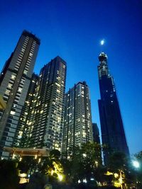 Low angle view of skyscrapers lit up at night