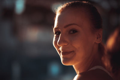 Close-up portrait of smiling young woman