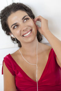 Woman listening music on headphones at home