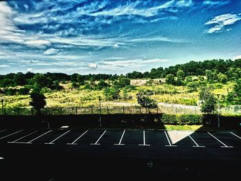 Scenic view of field against cloudy sky