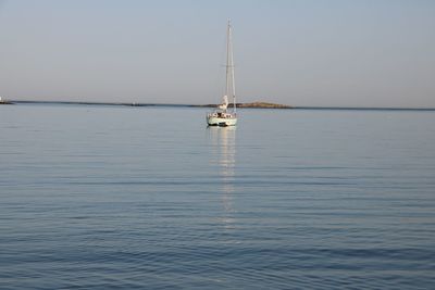 Sailboat sailing on sea against sky