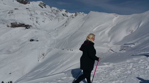 Full length of woman on snowcapped mountain