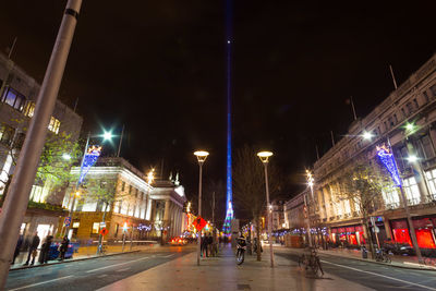 Illuminated city street at night