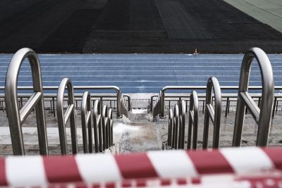 High angle view of empty chairs by the road