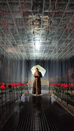 Woman standing in corridor