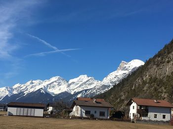 Scenic view of snowcapped mountains against blue sky