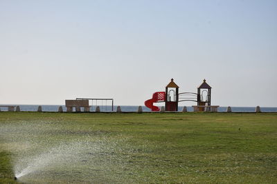 Built structure on beach against clear sky