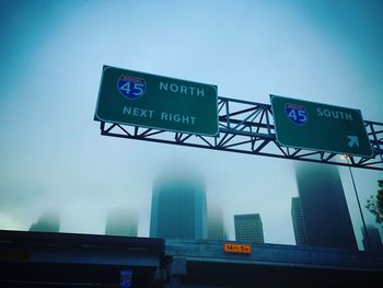 Low angle view of road sign against sky