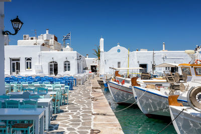 Boats moored in canal against buildings