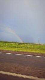 Scenic view of rainbow over field