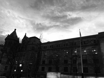 Low angle view of building against cloudy sky