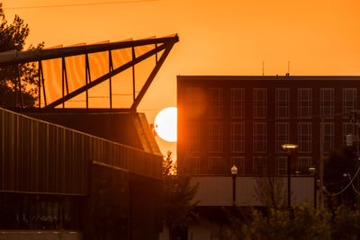 Silhouette bridge against sky during sunset