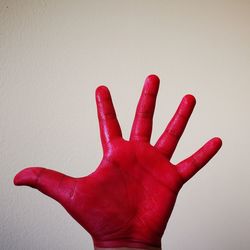 Close-up of hand against red background