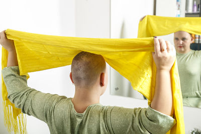 Rear view of woman holding umbrella