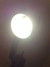 Low angle view of illuminated lamp against sky