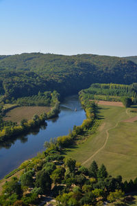 Scenic view of agricultural landscape against clear sky