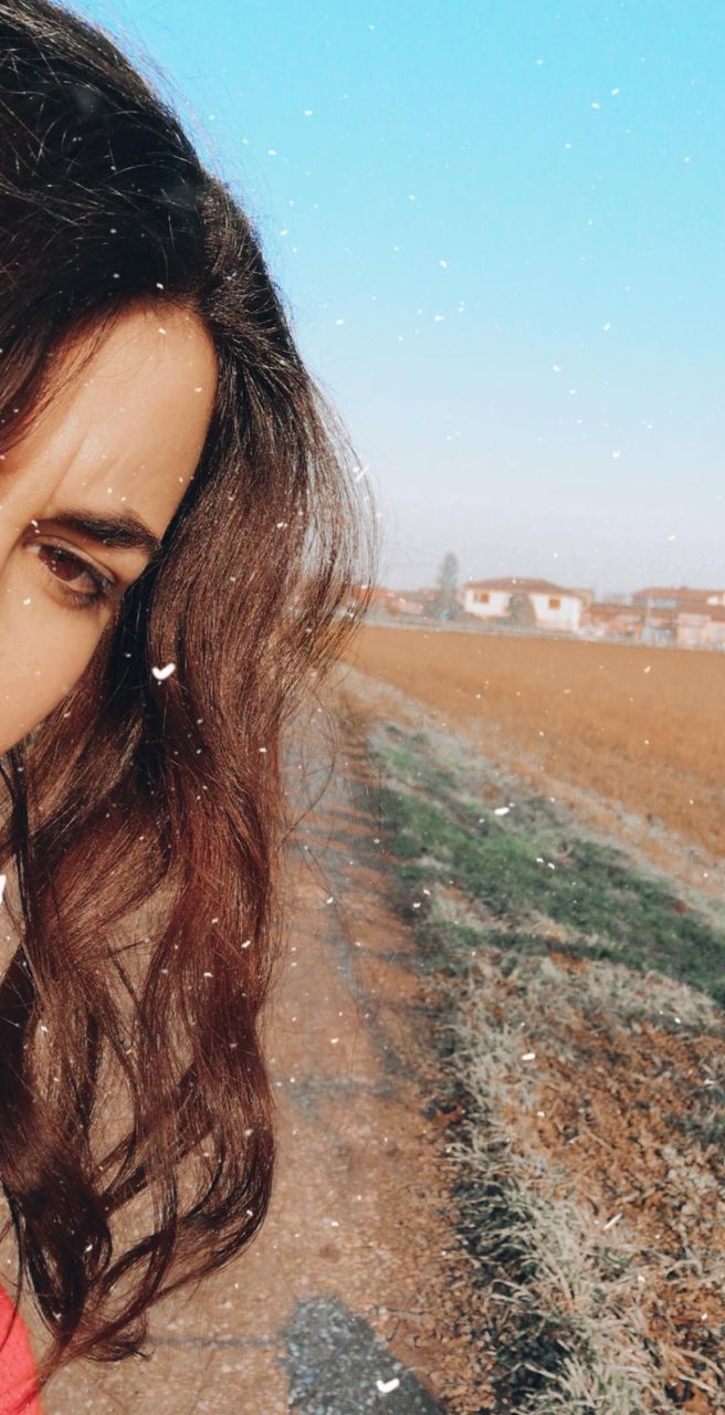 one person, portrait, young adult, young women, sky, hair, women, environment, leisure activity, beautiful woman, headshot, nature, real people, adult, lifestyles, hairstyle, beauty, brown hair, wind, outdoors, contemplation