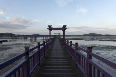 Pier over sea against sky