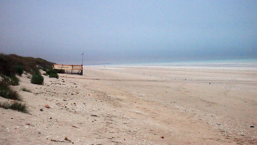 Scenic view of beach against clear sky