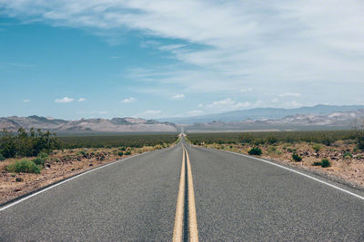 Empty road against sky