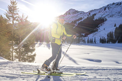 Man skiing on snowcapped mountains during winter