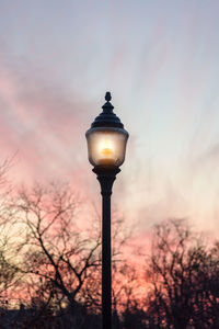 Low angle view of street light against sky during sunset