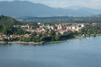 Scenic view of lake by buildings in city