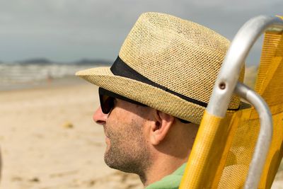 Close-up of man wearing hat at beach
