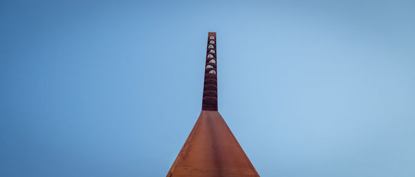 Low angle view of metallic structure against clear blue sky