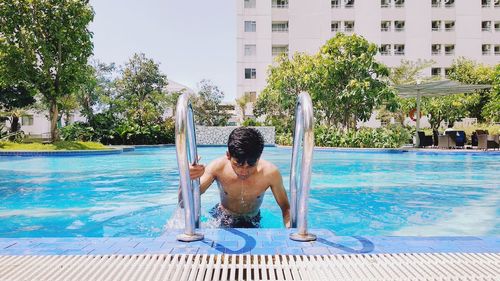 Shirtless man in swimming pool