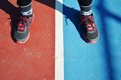 Low section of woman with sports shoes