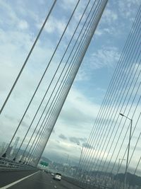 Low angle view of bridge against cloudy sky