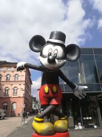 Low angle view of sculpture against building in city