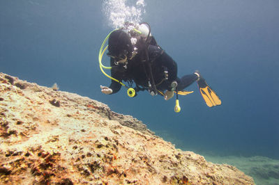 Woman scuba diving in sea