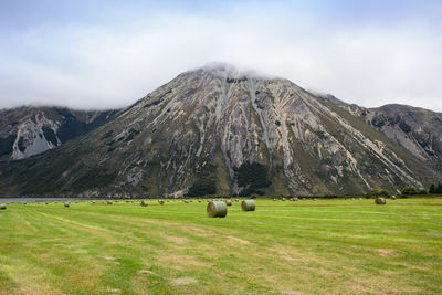 Scenic view of field and mountains against sky