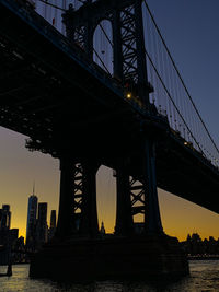 Low angle view of suspension bridge at sunset