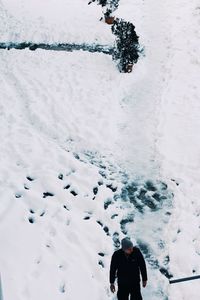 High angle view of man on snow covered landscape