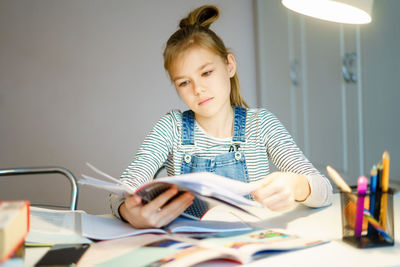 Portrait of a girl sitting on table