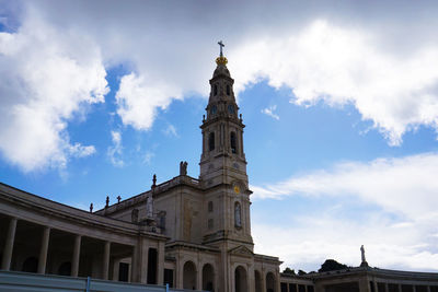 Low angle view of clock tower against sky